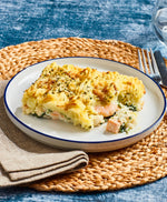 Bistro Chef fish pie served on a white plate, a table mat and napkin. The pie shows the fish, prawns and potato topping